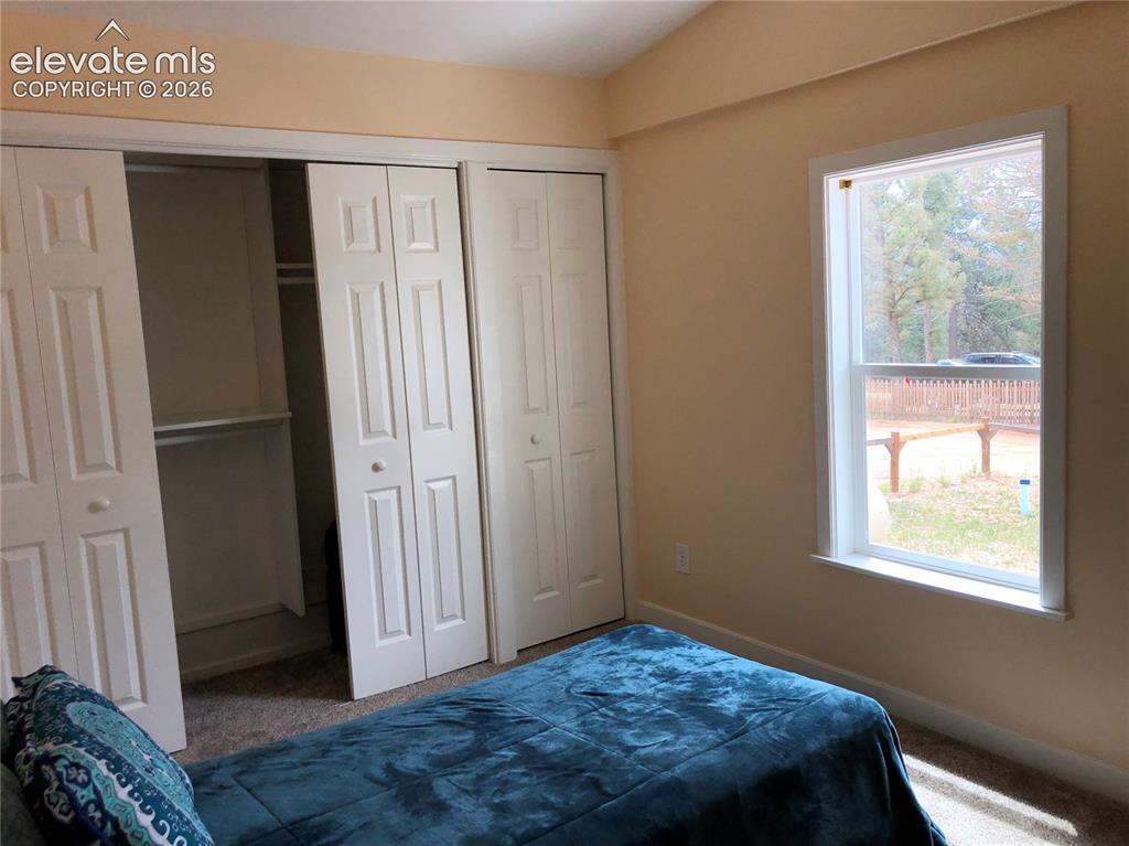 Image 14 of 25: Second Bedroom has Sunny Pikes Peak Views!