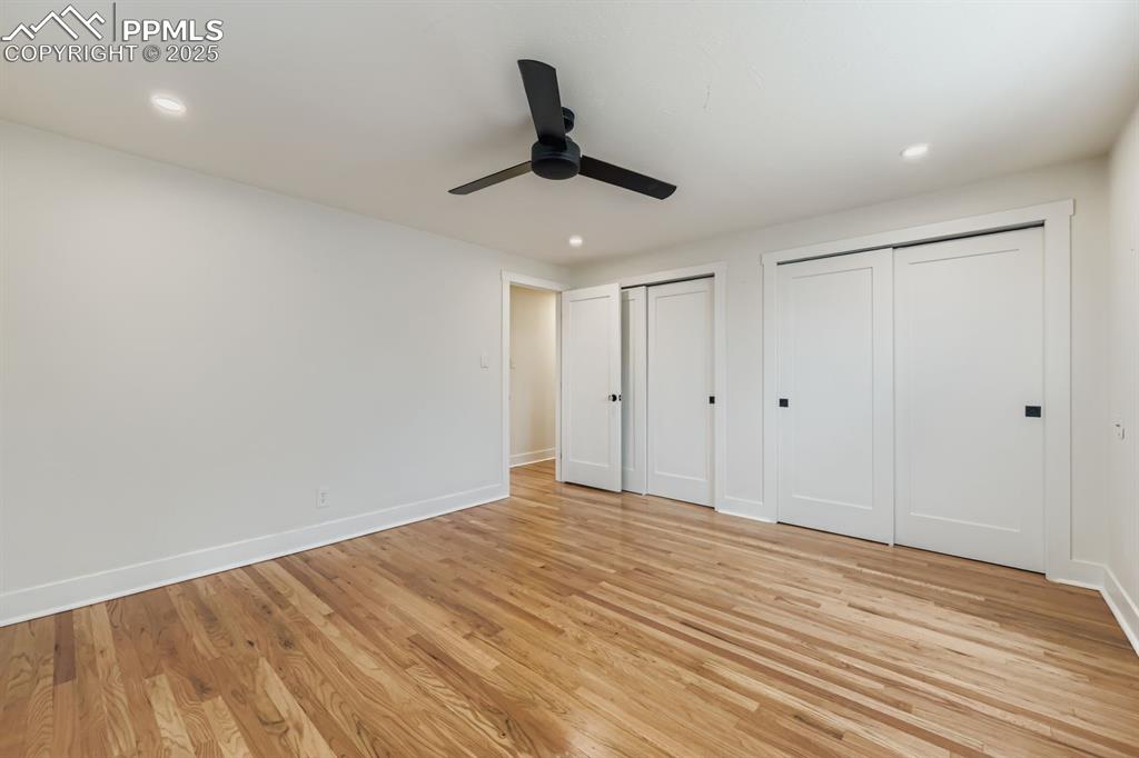 Image 14 of 28: Unfurnished bedroom featuring multiple closets, recessed lighting, light wo