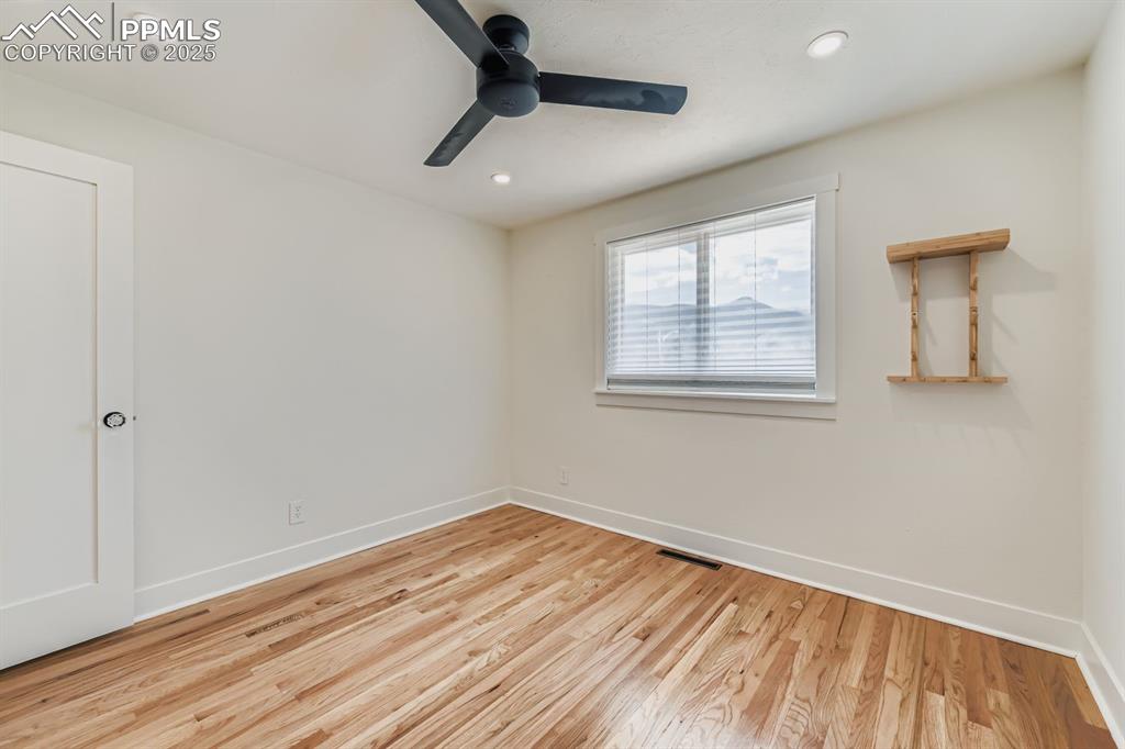 Image 18 of 28: Empty room with light wood finished floors, recessed lighting, and ceiling