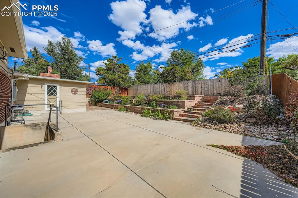 Image 24 of 28: Fenced backyard featuring a patio