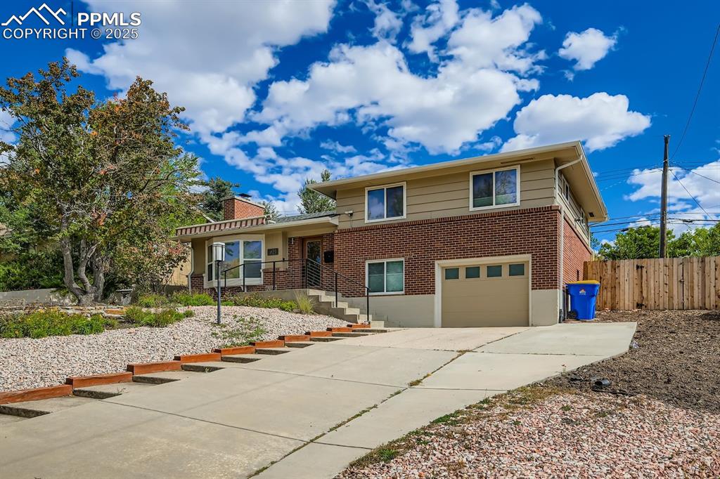 Image 28 of 28: View of front of property featuring brick siding, concrete driveway, an att