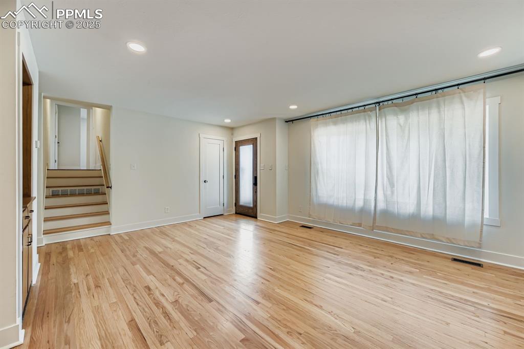 Image 9 of 28: Unfurnished living room featuring light wood-style flooring, recessed light