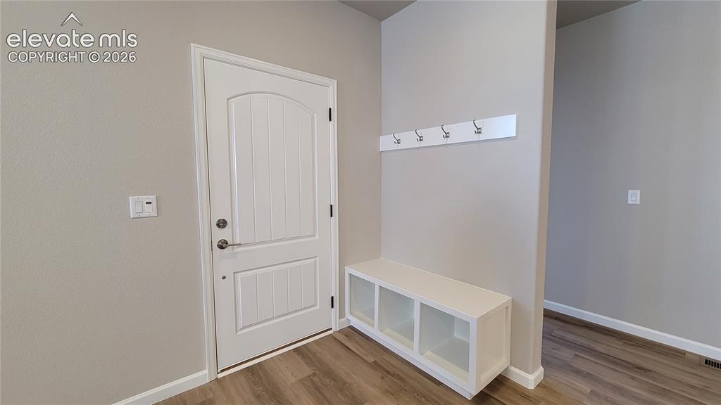 Image 5 of 42: Entryway with a boot bench and coat hooks!