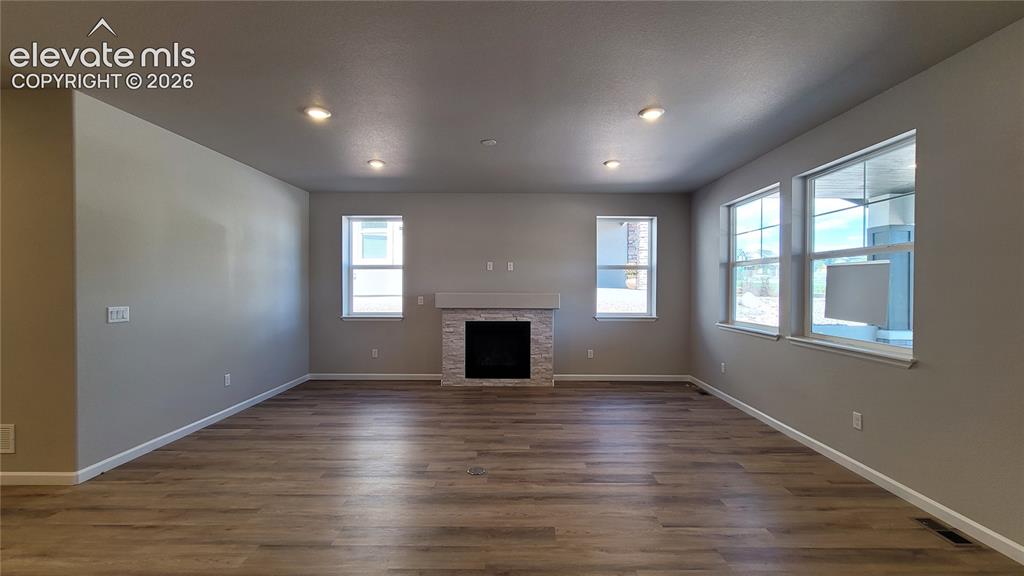 Image 7 of 42: Spacious Living Room with LVP flooring, floor outlet, LED lighting, abundan