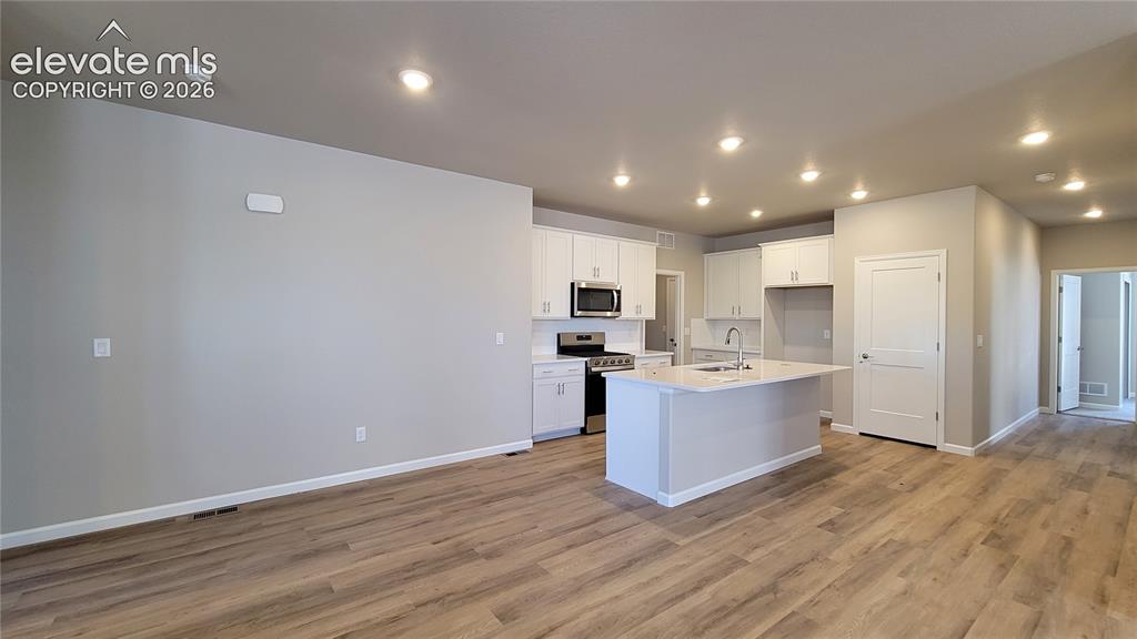 Image 9 of 42: Dining area with LVP flooring and LED Lighting!