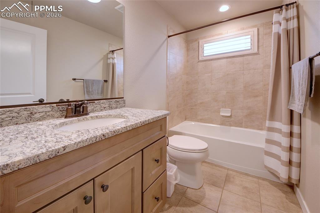 Image 19 of 36: Hall bathroom granite counters and ceramic tile floor on main level and ful