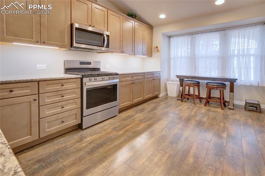 Image 2 of 36: Kitchen 42" designer cabinetry and hardware, gas range/oven, and LVT