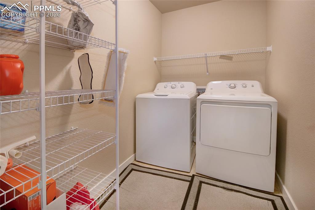 Image 20 of 36: Laundry room on main level near master bedroom and appliances stay