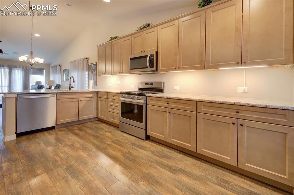 Image 4 of 36: Kitchen granite counter tops and under cabinet lighting