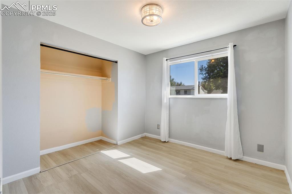 Image 16 of 23: Unfurnished bedroom featuring light wood finished floors and a closet