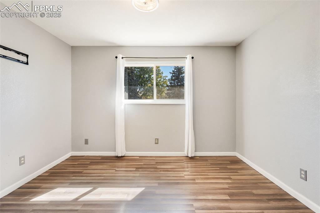 Image 19 of 23: Unfurnished room with light wood finished floors
