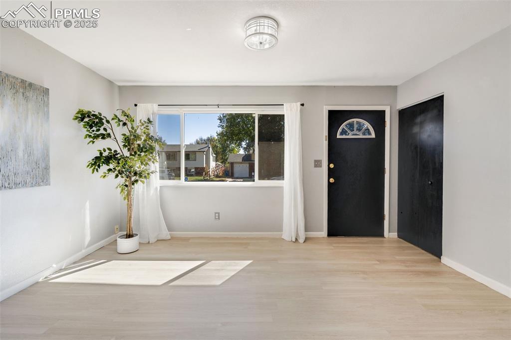 Image 2 of 23: Foyer with wood finished floors