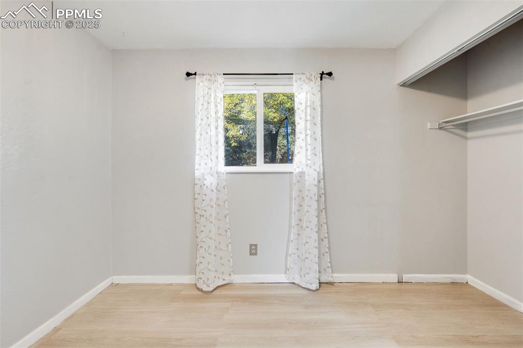 Image 22 of 23: Spare room featuring light wood-style flooring and baseboards