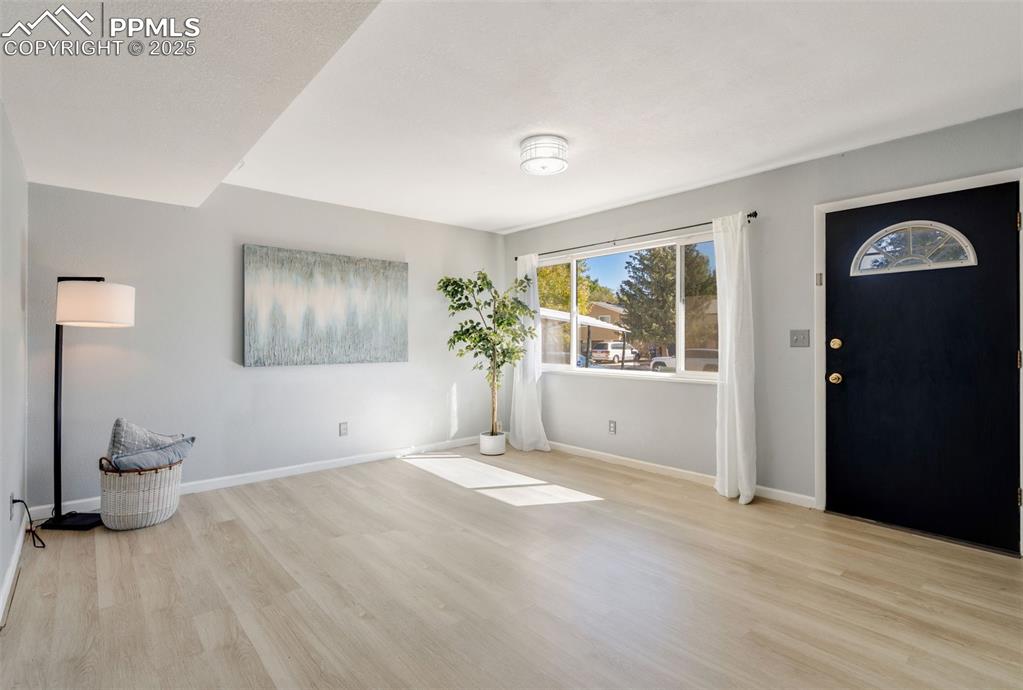 Image 3 of 23: Foyer with light wood-style flooring and baseboards