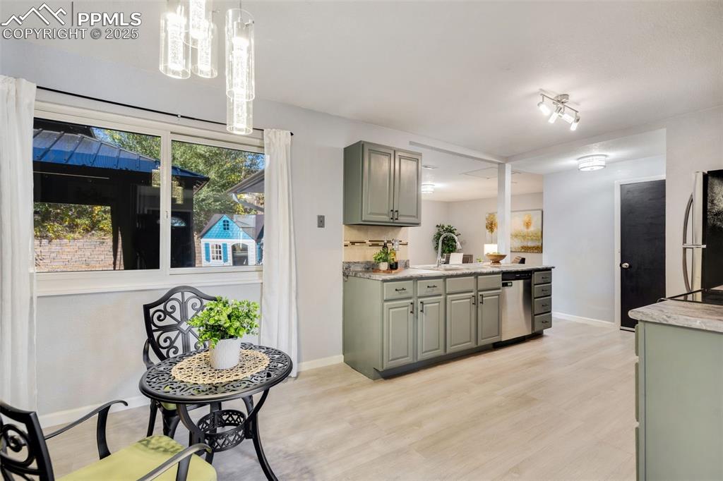 Image 5 of 23: Kitchen with light countertops, light wood-style floors, stainless steel ap