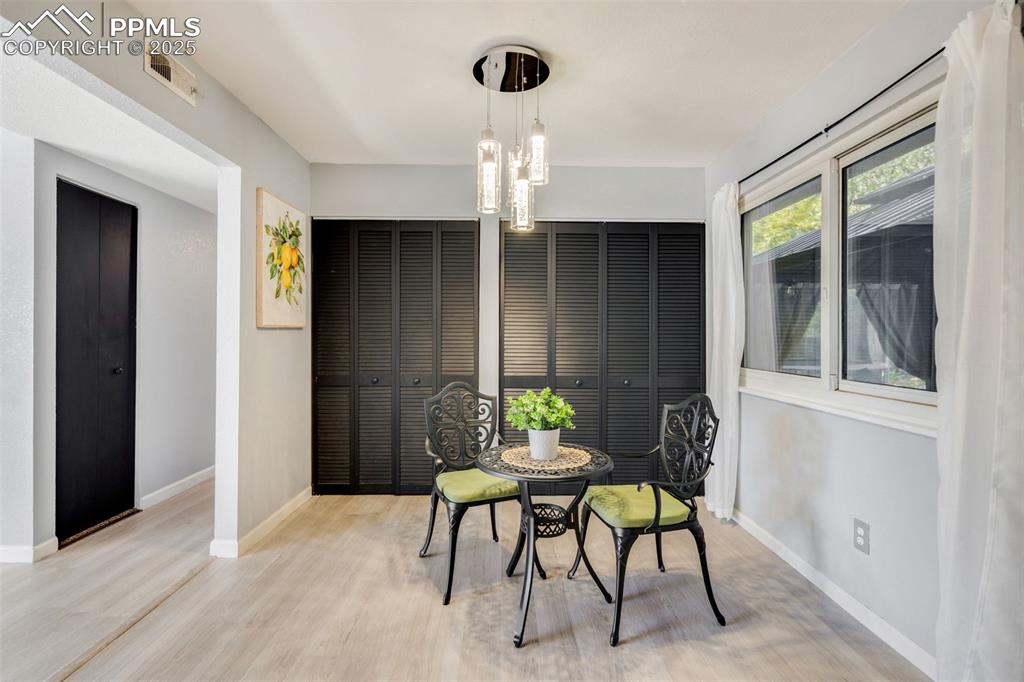 Image 6 of 23: Dining space featuring a chandelier and light wood-style flooring