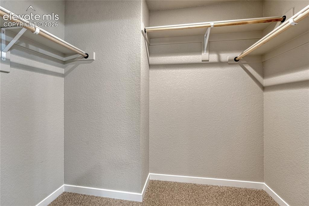 Image 16 of 30: Walk-in closet in primary suite. 