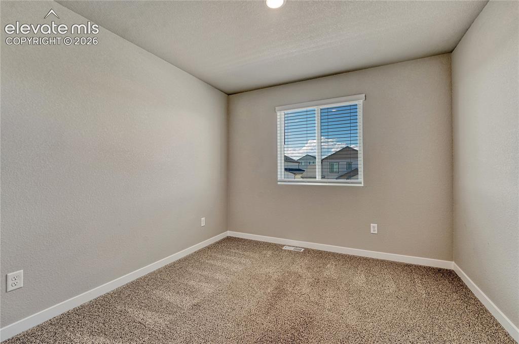 Image 19 of 30: First of three additional bedrooms. 