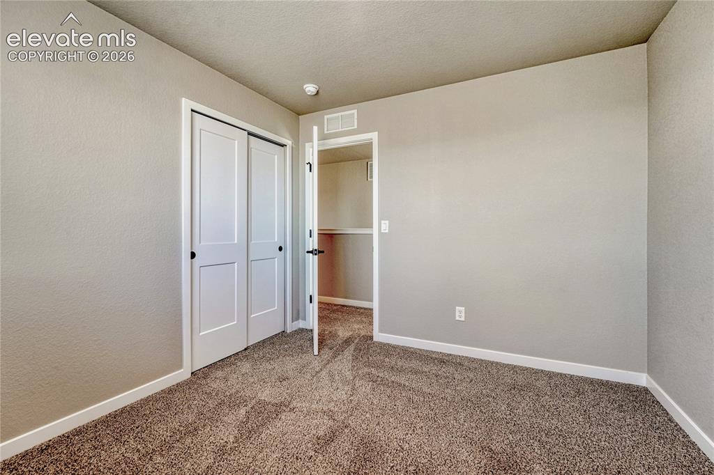 Image 21 of 30: Second of three additional upstairs bedrooms. 