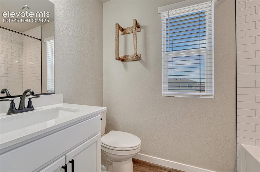 Image 23 of 30: Full upstairs bath with quartz countertop...