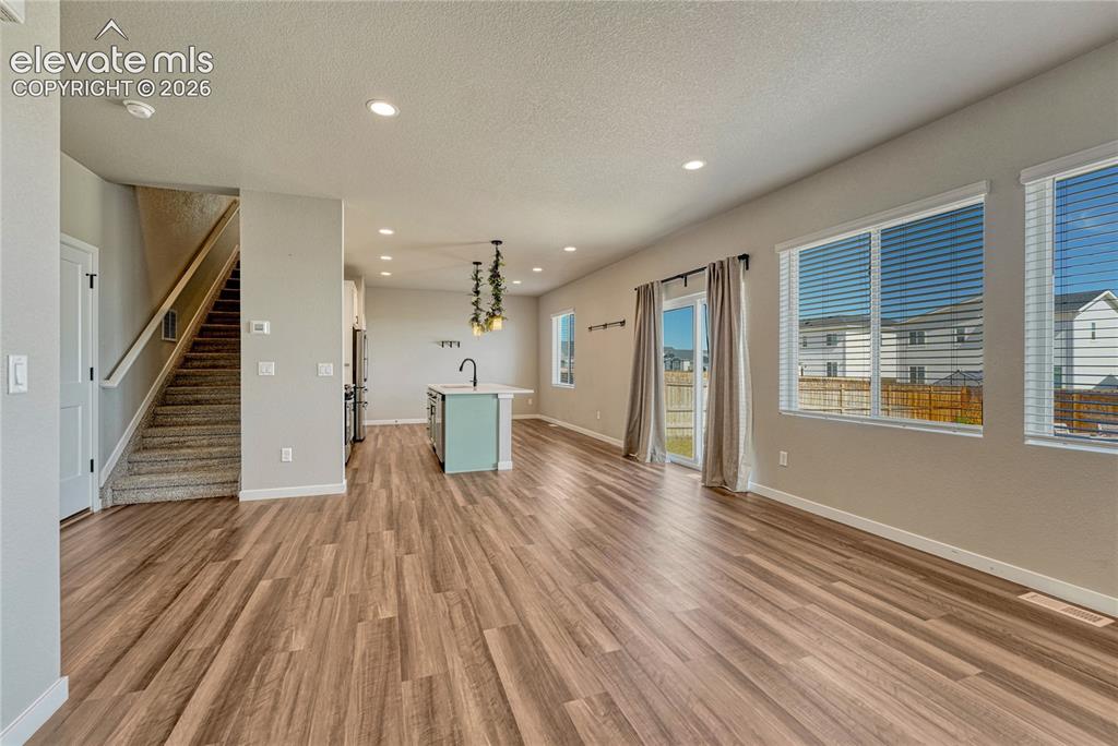 Image 3 of 30: Great room with luxury vinyl flooring, abundant natural light...