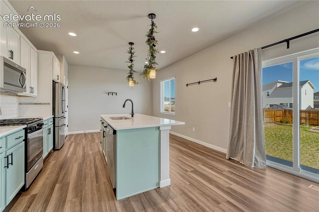 Image 6 of 30: Note the 2-tone cabinetry and luxury vinyl flooring. 