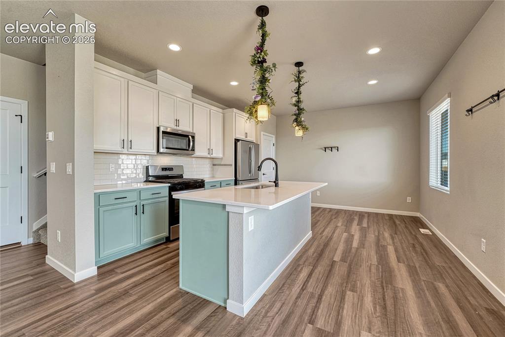 Image 7 of 30: Kitchen offers a large island, pantry, stainless steel appliances...