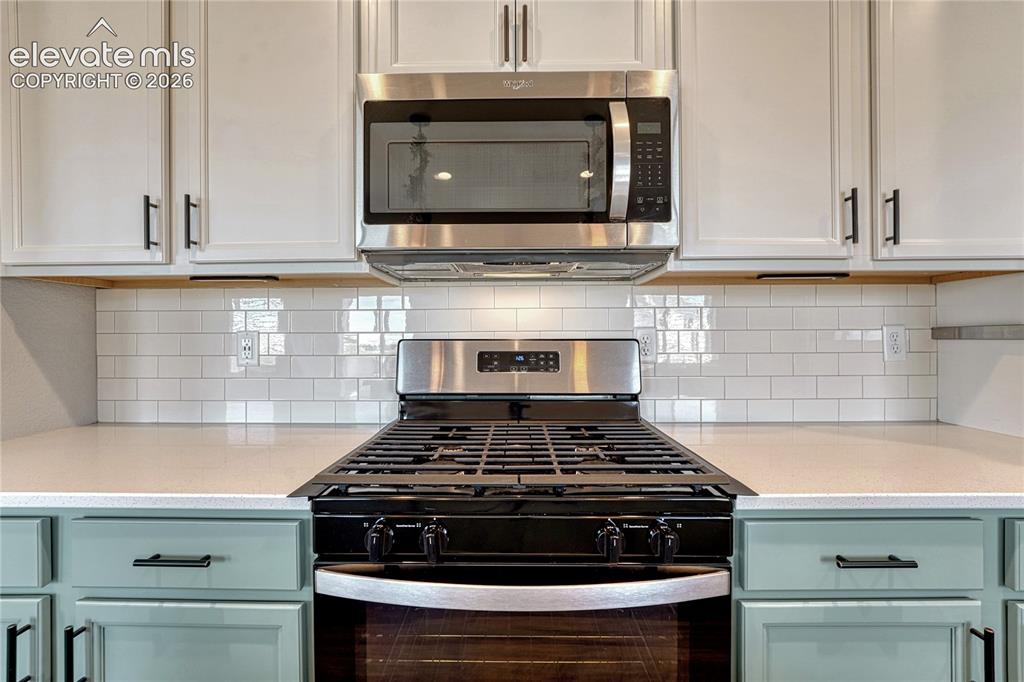 Image 8 of 30: ...quartz countertops and gas range.