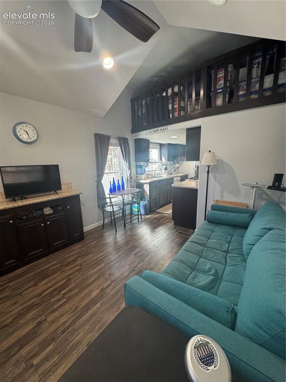 Image 6 of 12: Vaulted ceiling with integrated ceiling fan, wood-finish flooring, dark-ton