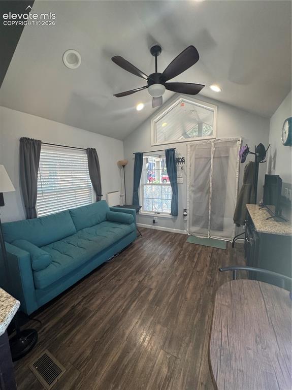 Image 7 of 12: Vaulted ceilings featuring a central ceiling fan, wood-finish flooring, and