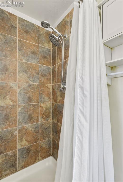 Image 22 of 34: Full bathroom with a stall shower