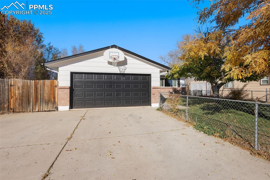 Image 33 of 34: View of garage & extra parking