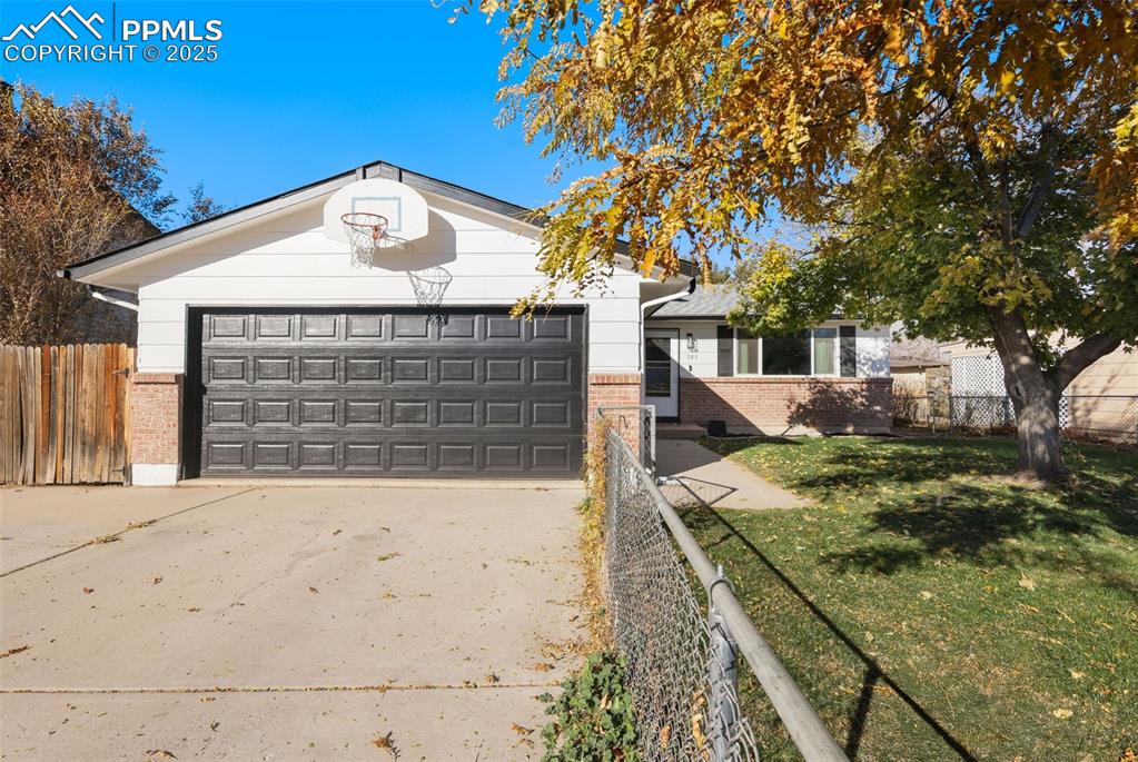 Image 34 of 34: View of front of property featuring brick siding, concrete driveway, and an