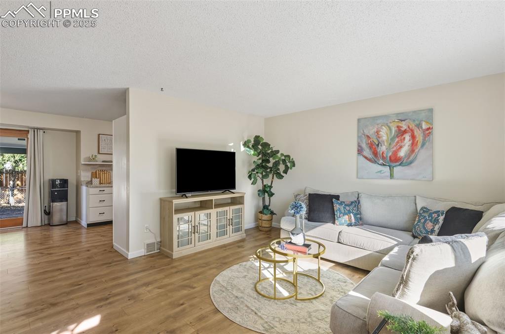 Image 4 of 34: Living area with new wood finished floors 