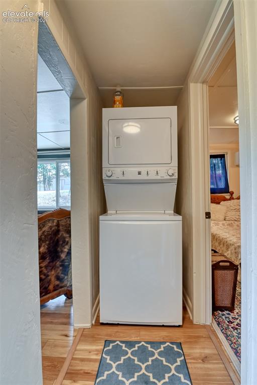 Image 19 of 47: Stacked white laundry machine conveniently tucked away.