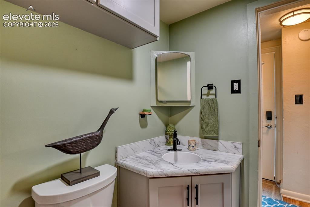 Image 24 of 47: Newly remodeled bathroom featuring a corner vanity with a white vessel sink