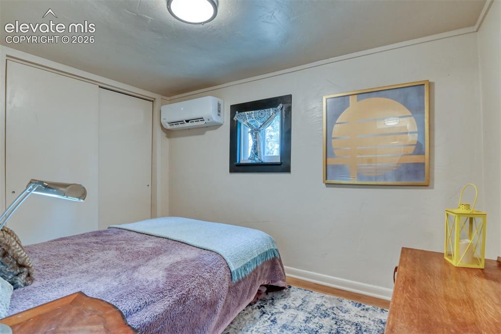 Image 26 of 47: Interior room featuring a wall-mounted mini-split HVAC unit, a window with
