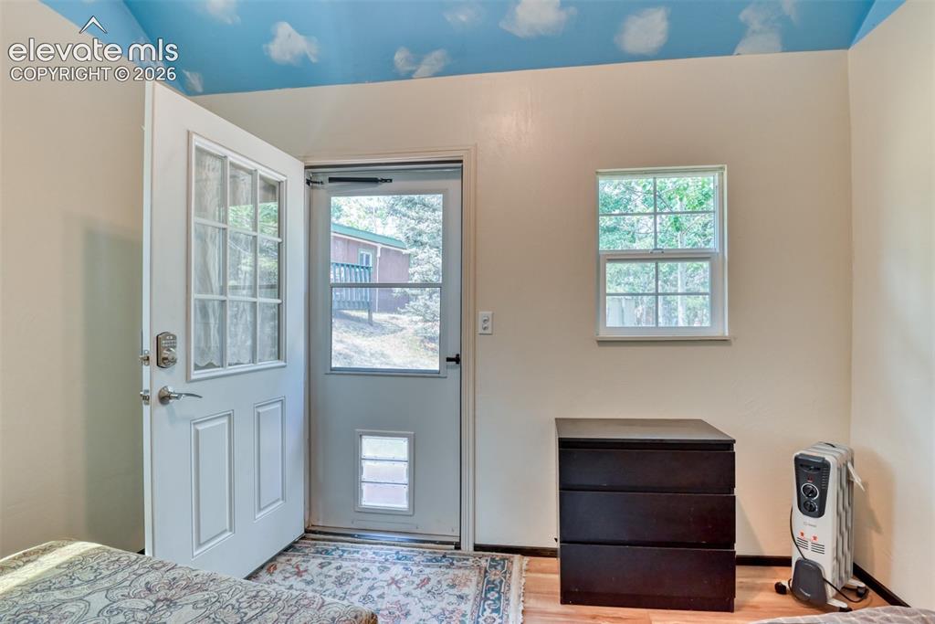 Image 32 of 47: Entryway featuring a secure door with multi-pane glass, a screen door with