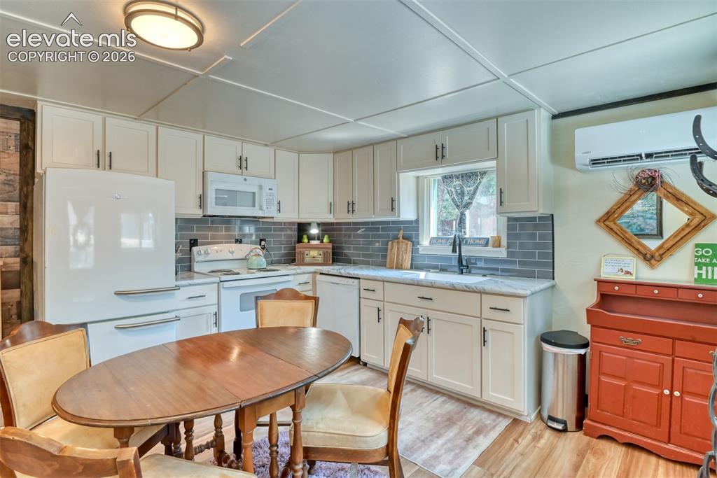 Image 4 of 47: Newly remodeled Kitchen featuring off white cabinetry with dark hardware, s