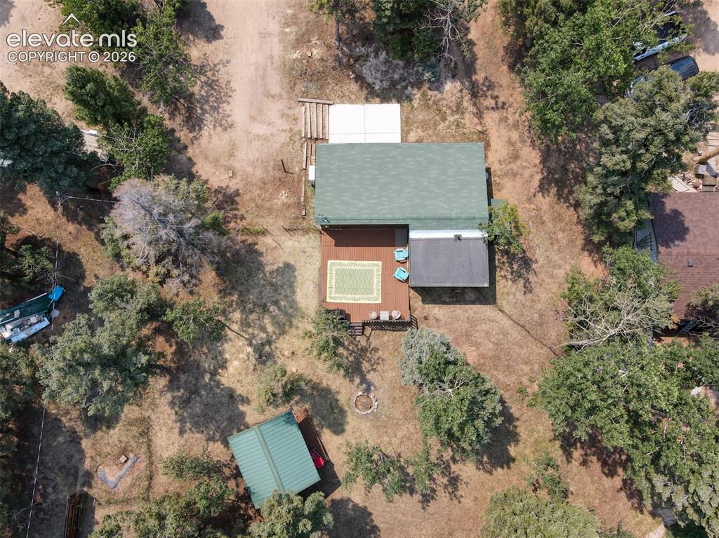 Image 47 of 47: Overhead property view featuring a residence with a green shingle roof, an