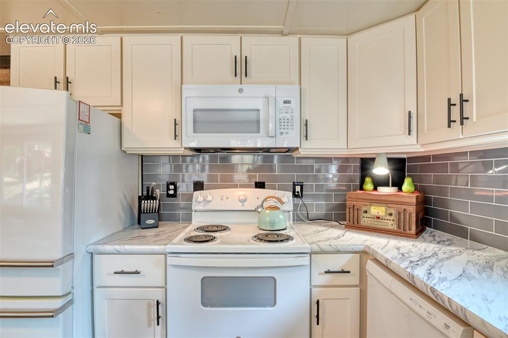 Image 5 of 47: Kitchen cabinets are a very nice addition. The beautiful countertops are n