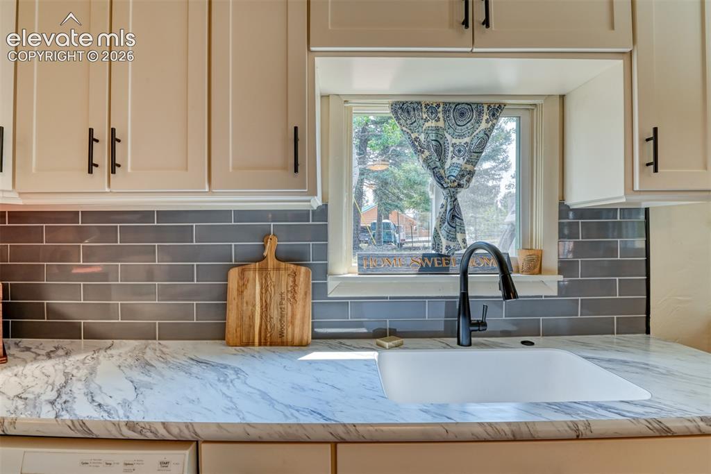 Image 7 of 47: Just look at these elegant countertops, excellent sink and modern faucet!