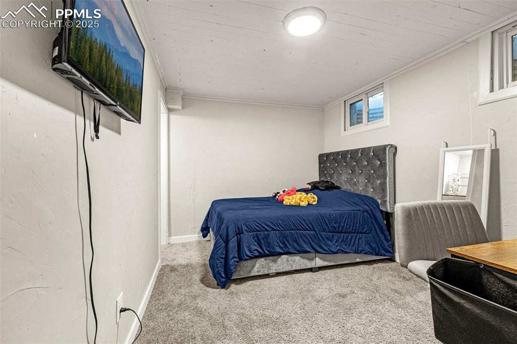 Image 19 of 37: Bedroom with carpet flooring and a textured wall