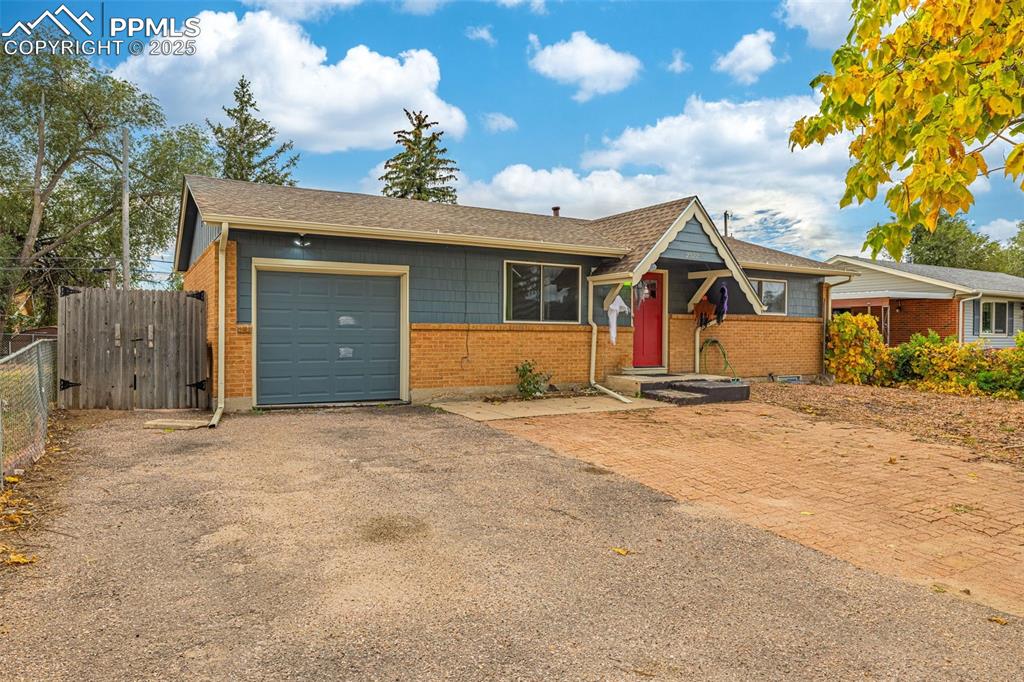 Image 2 of 37: View of front of house featuring a shingled roof, asphalt driveway, a garag