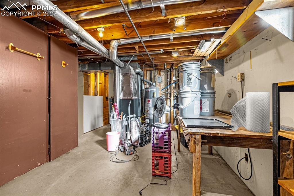 Image 22 of 37: Unfinished below grade area featuring gas water heater