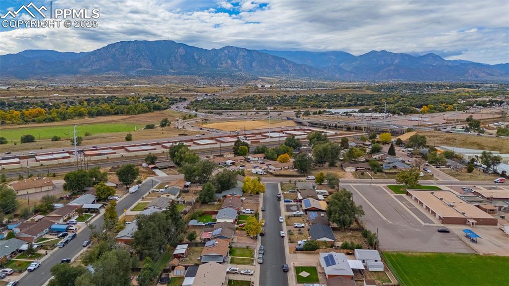 Image 35 of 37: Aerial view of residential area with a mountainous background