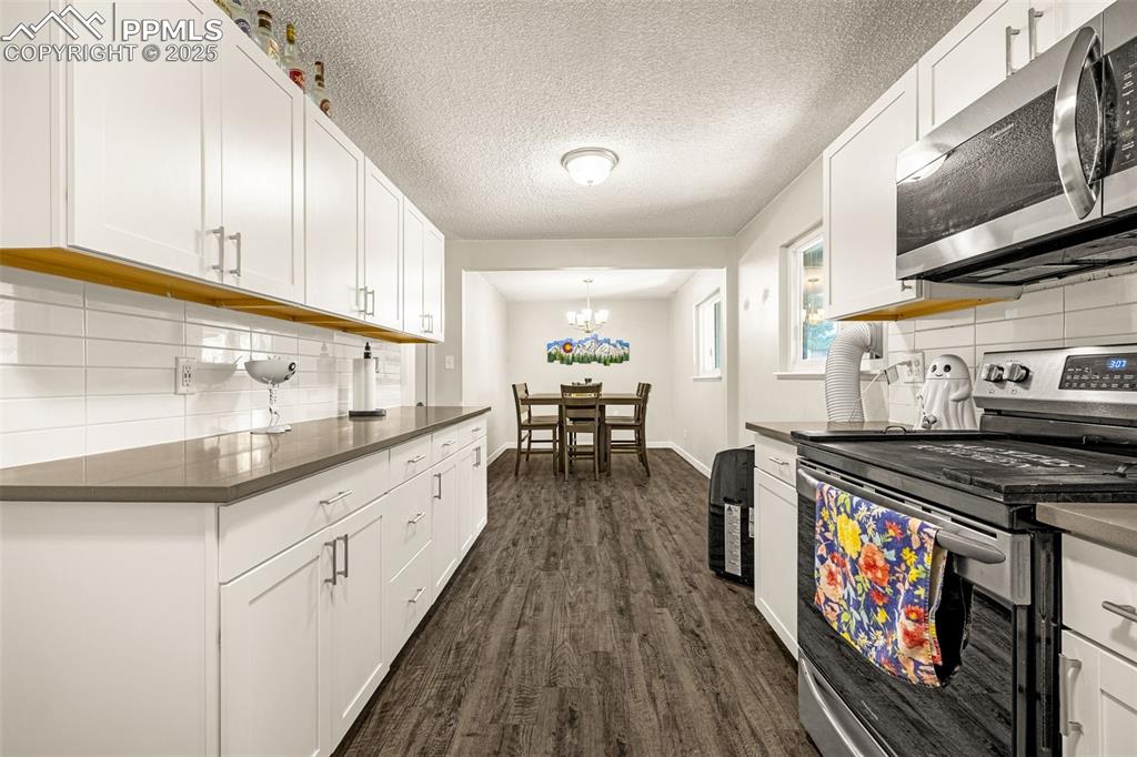 Image 9 of 37: Kitchen featuring tasteful backsplash, appliances with stainless steel fini