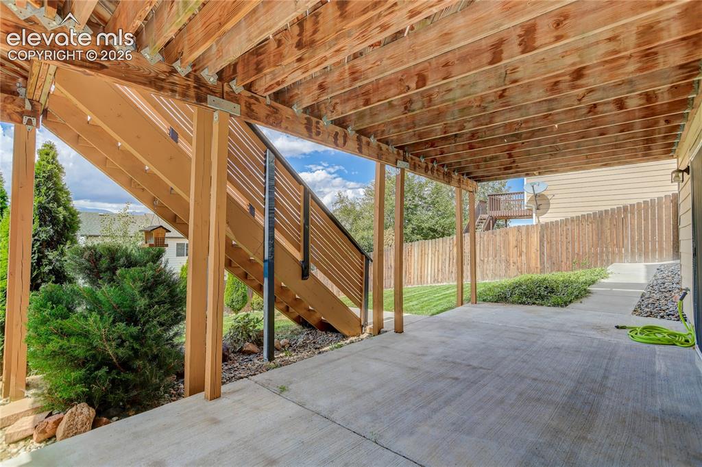 Image 25 of 31: Walk-out patio from unfinished basement
