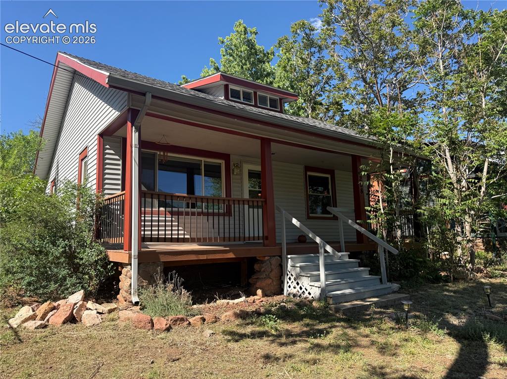 Image 1 of 15: Charming exterior featuring horizontal siding, a covered front porch with d