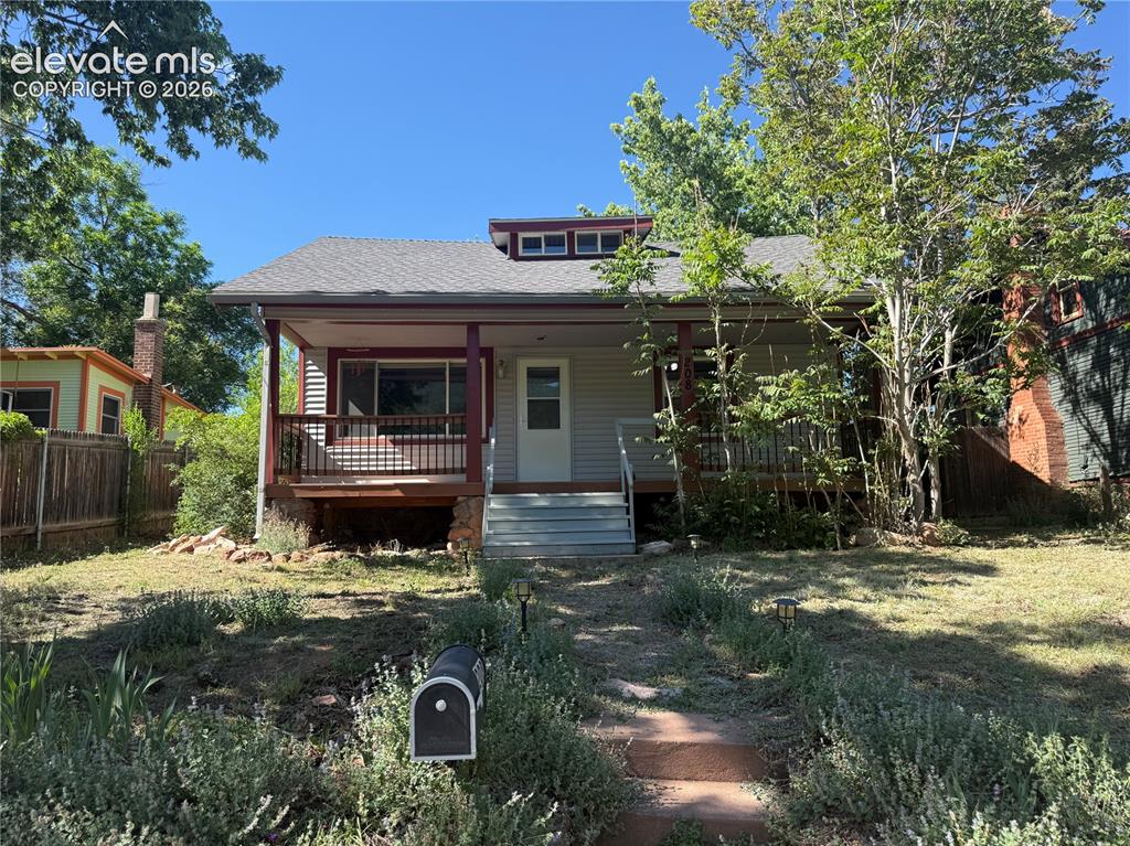 Image 2 of 15: Charming cottage-style residence featuring a covered front porch, grey hori